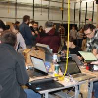 event area full of attendees looking at senior projects